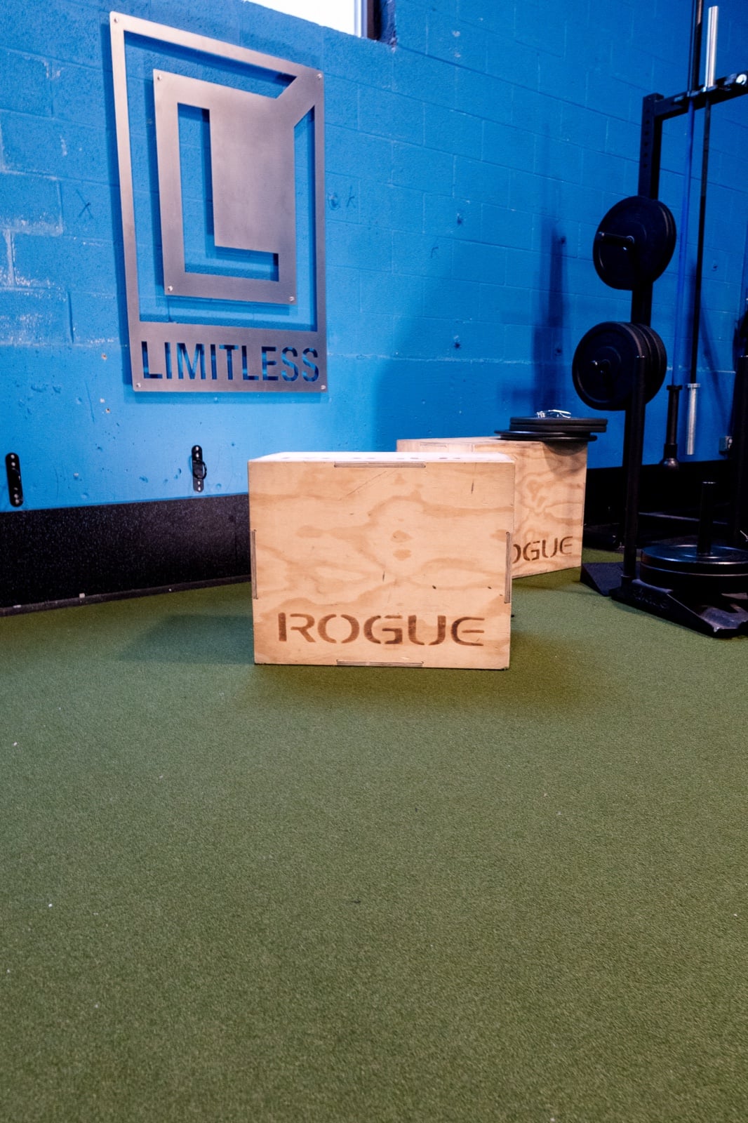 Limitless gym with plyometric boxes, strength equipment, and the Limitless wall mark